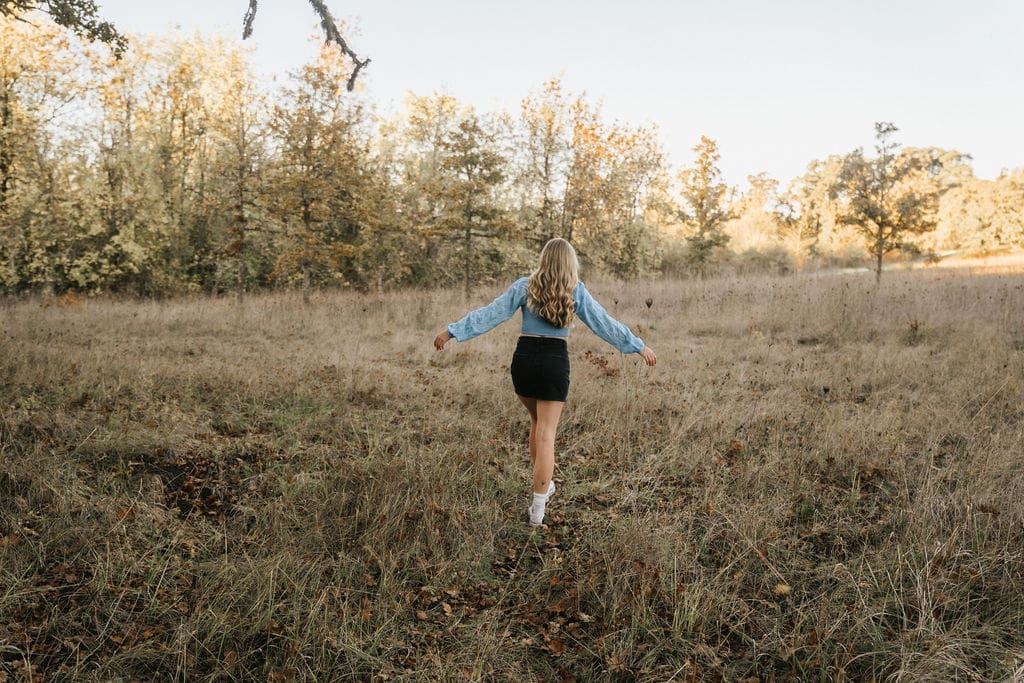 senior running through field at sunset in springfield, oregon