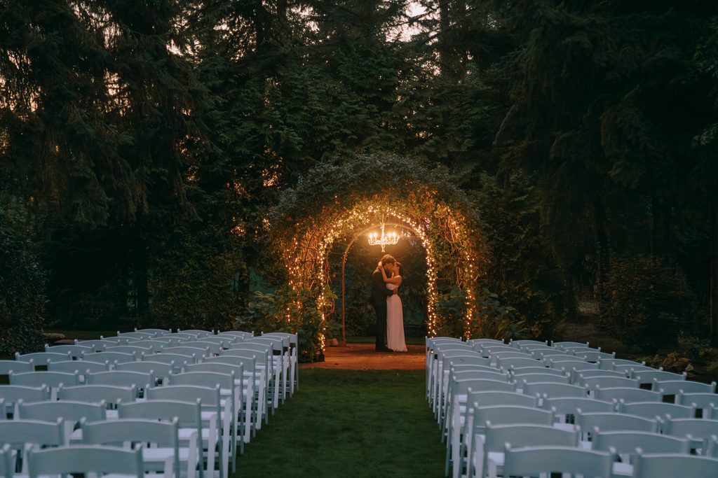 couple kissing under wedding gazebo during wedding at garden at riverside in corvallis, oregon