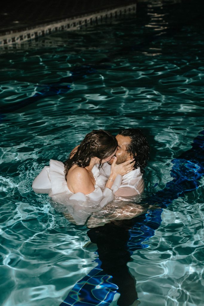 couple jumps in pool after their wedding